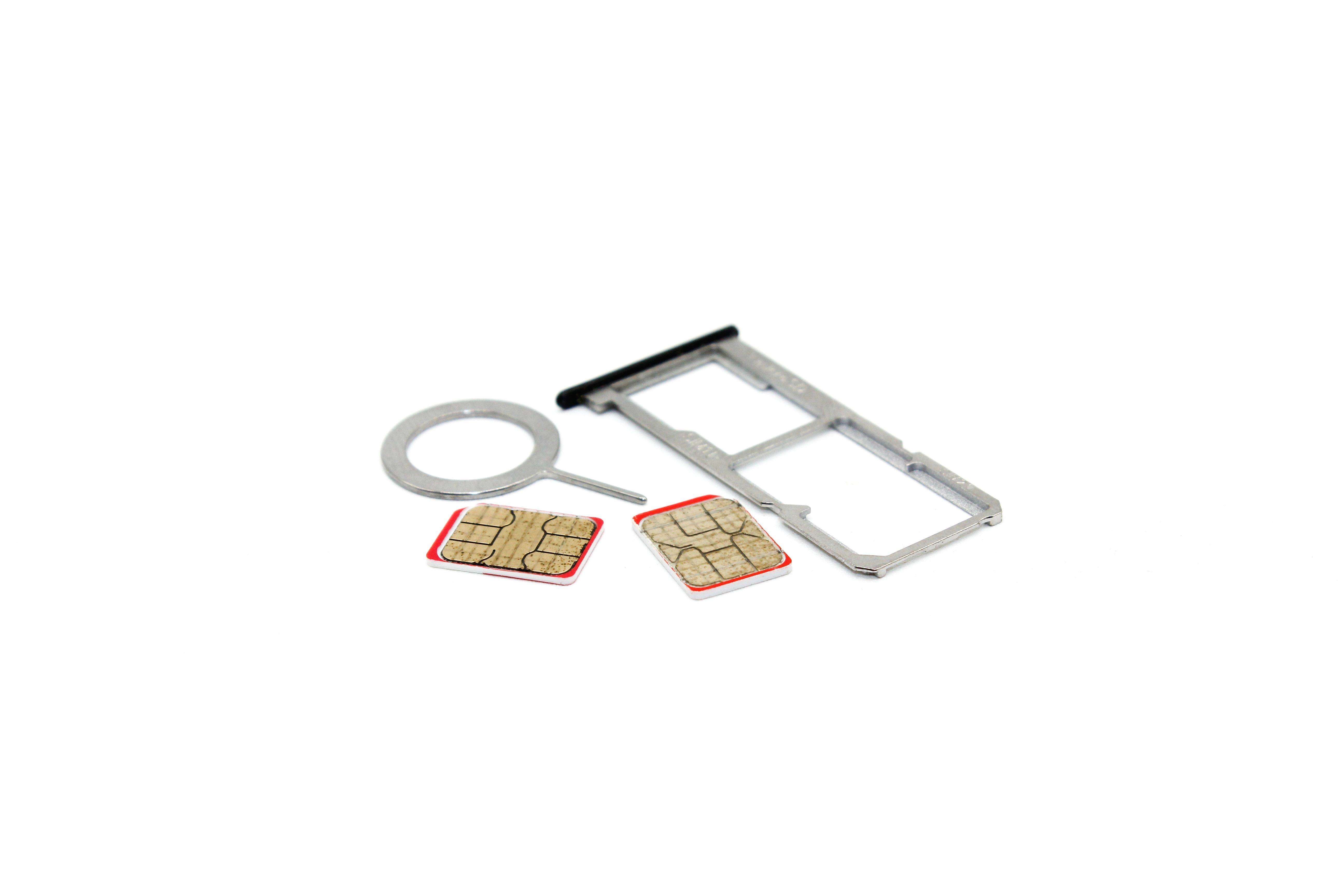close-up-of-a-sim-card-next-to-an-open-sim-tray-2023-11-27-05-30-15-utc