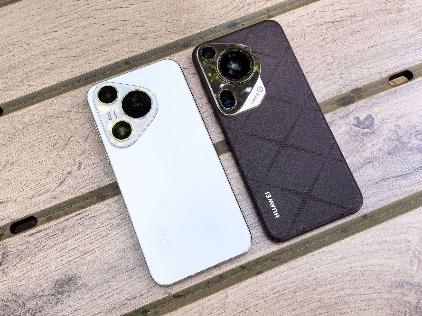 Two modern smartphones displayed on a wooden surface, showcasing sleek design and camera features.
