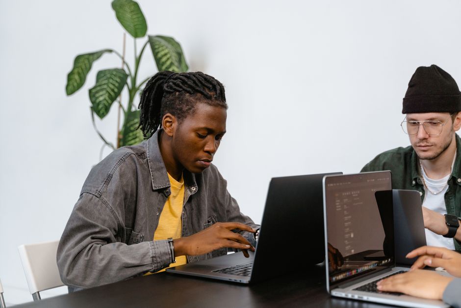 Company Windows laptops managed from a single MDM console. Photo by MART  PRODUCTION on Pexels